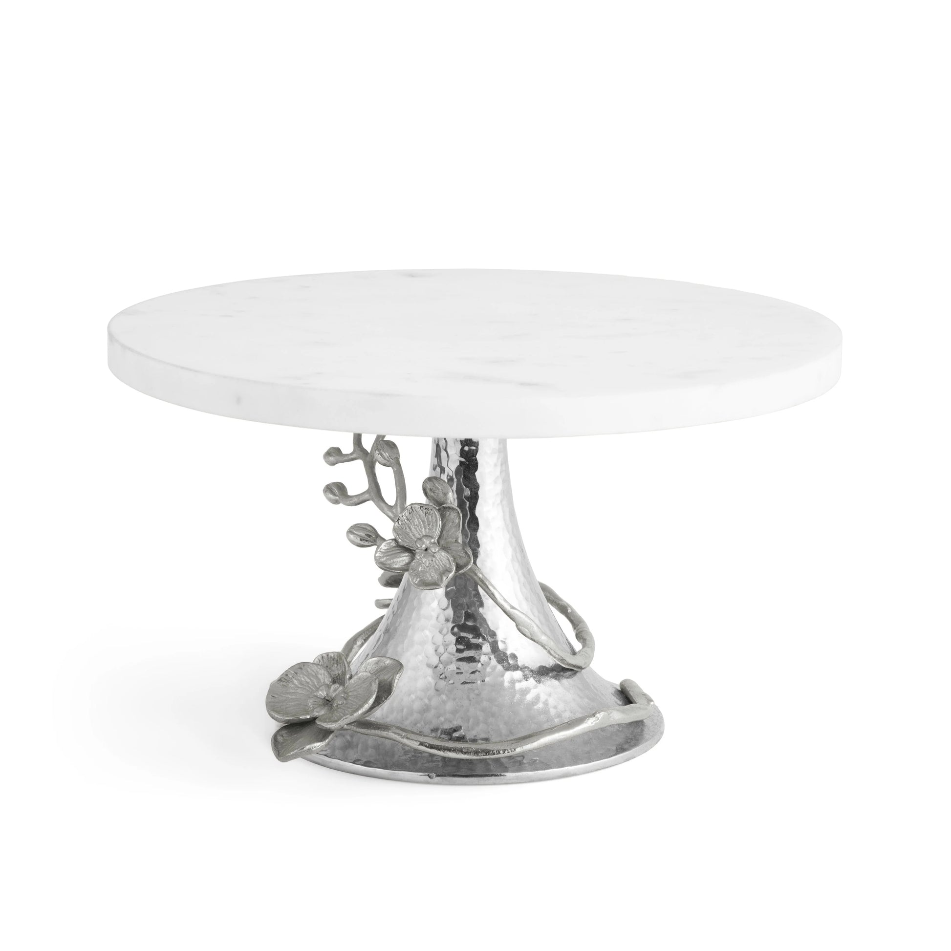 A round white marble cake stand from Michael Aram's White Orchid Serveware Collection, featuring a hammered silver base with an elegant floral and vine motif.