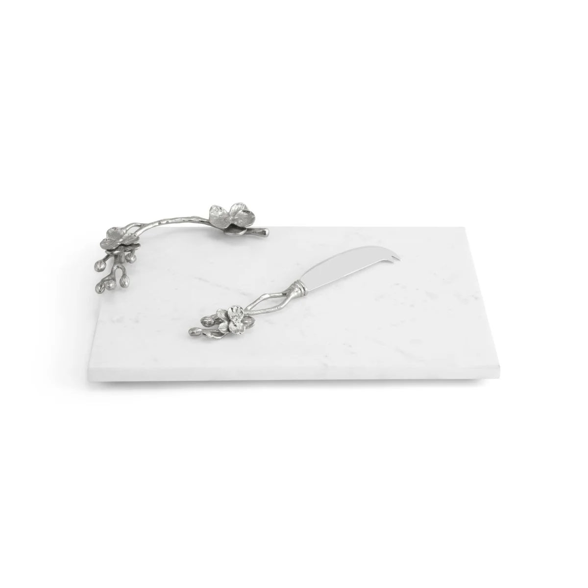 The Michael Aram White Orchid Serveware Collection features a rectangular white marble cheese board with a silver orchid handle and a matching floral cheese knife, perfect for adding elegance to any gathering.