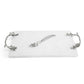 The Michael Aram White Orchid Serveware Collection features a rectangular white marble serving tray with ornate silver handles and a matching spreader, capturing elegance and purity in every detail.