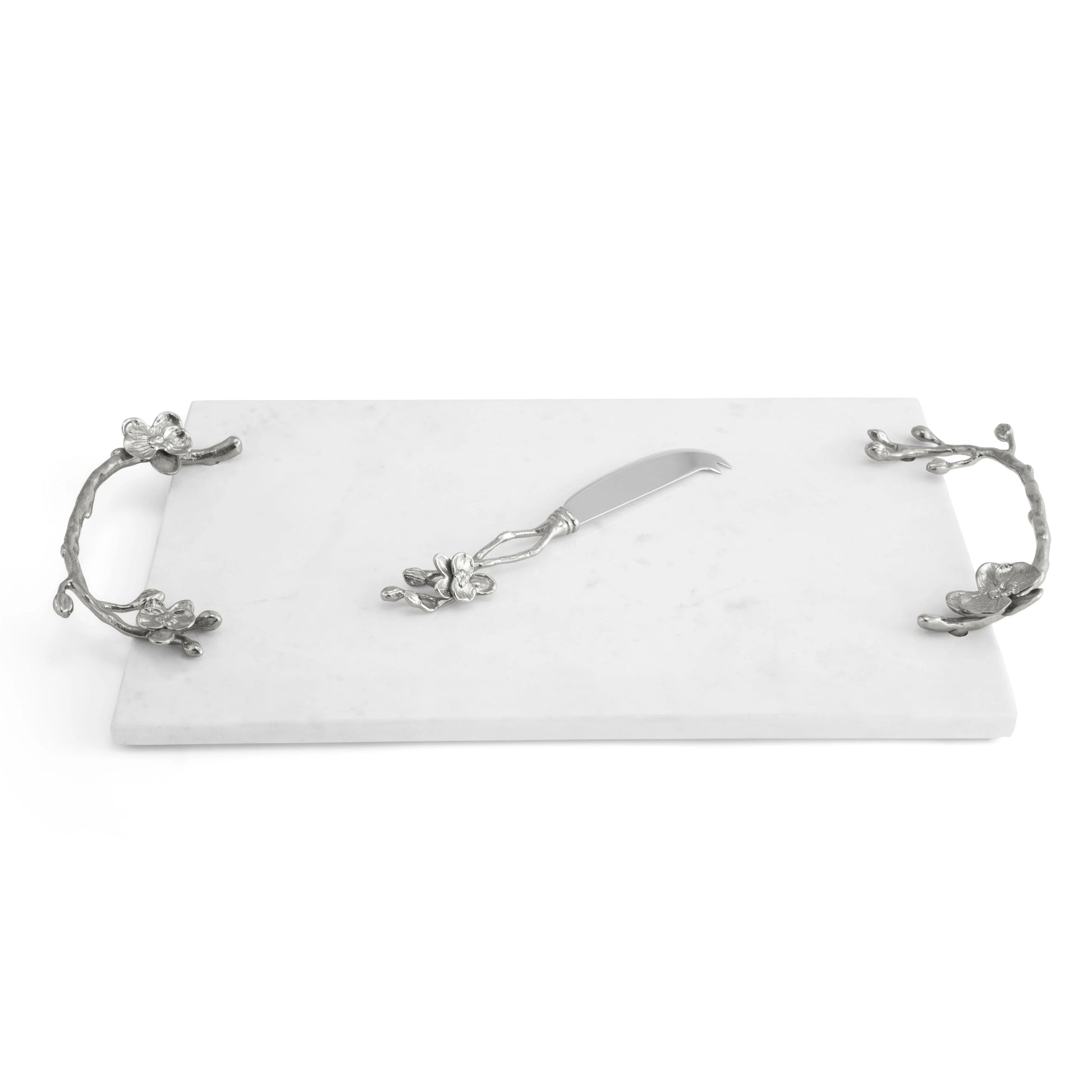 The Michael Aram White Orchid Serveware Collection features a rectangular white marble serving tray with ornate silver handles and a matching spreader, capturing elegance and purity in every detail.