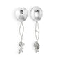 Two metal serving spoons from the Michael Aram White Orchid Serveware Collection feature hammered bowls and decorative floral, branch-inspired handles for a touch of mystery.