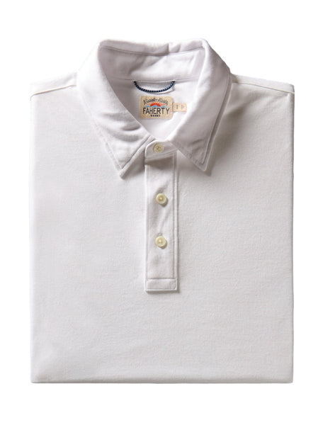 A folded white collared Faherty Movement Short-Sleeve Pique Polo with a relaxed fit, featuring three buttons and a visible label that reads "Faherty.