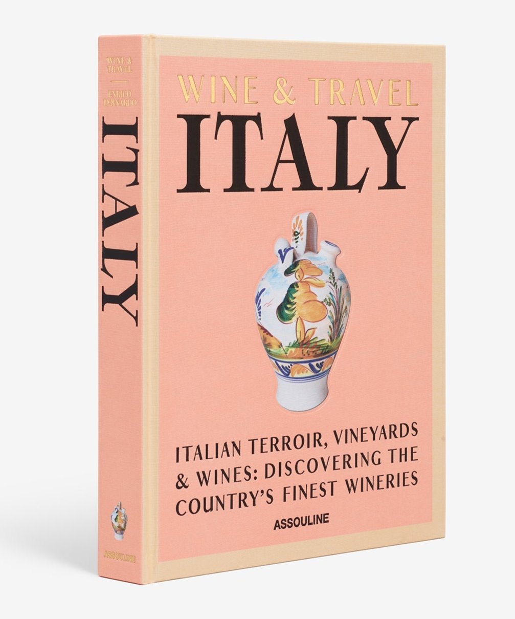 Assouline's "Wine & Travel Italy," featuring a pink cover adorned with a decorative vase illustration, is an essential read for anyone passionate about wine tourism and eager to discover Italian vineyards.