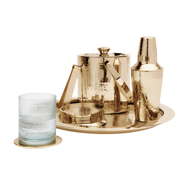 The Blue Pheasant Winsford Barware set by Blue Pheasant in shiny brass includes a shaker, ice bucket, tongs, tray, strainer, and a crisscross-patterned glass with matching coaster for the modern bar.