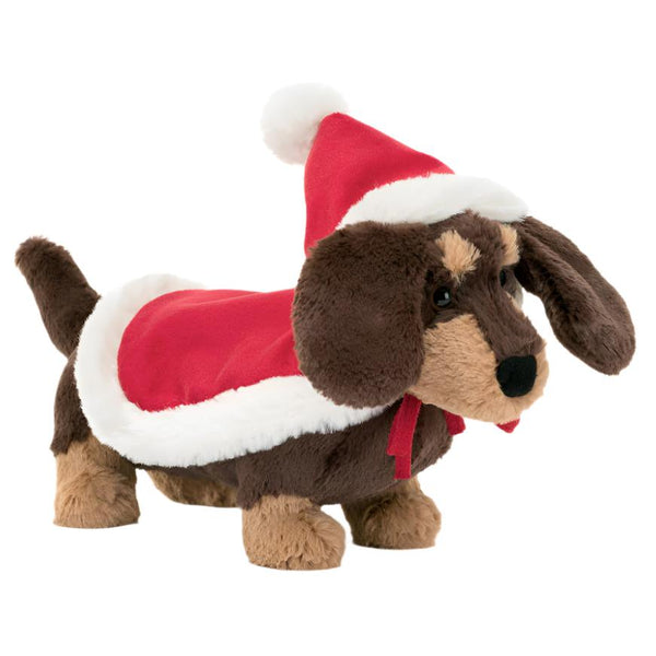 Introducing the Jellycat Winter Warmer Otto Sausage Dog—a plush toy from Jellycat dressed in festive holiday style with a red and white Santa hat and cape, perfect for cozy snuggles by the fire.