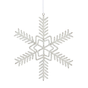 The Pearl Beaded Snowflake Ornament by Park Hill Collection features an elegant design and hangs from a white ribbon, creating a winter-inspired accent against any background.