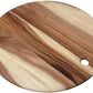 The Be Home Acacia Wood Round Board Collection features handcrafted round boards with a small circular hole near the edge, showcasing beautiful natural acacia wood grain patterns.
