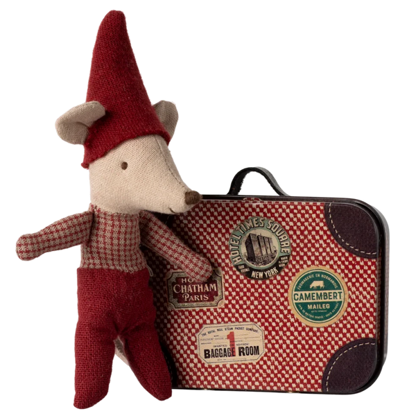 The Maileg Christmas Mouse, Baby in Suitcase, made from recycled polyester, wears a red outfit and hat while standing beside its travel suitcase embellished with colorful stickers.