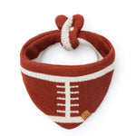 The Football Knit Dog Bandana from The Foggy Dog features a sporty brown and white football-inspired design and an adjustable snap closure for a secure fit—making it the perfect game day essential for your pup.
