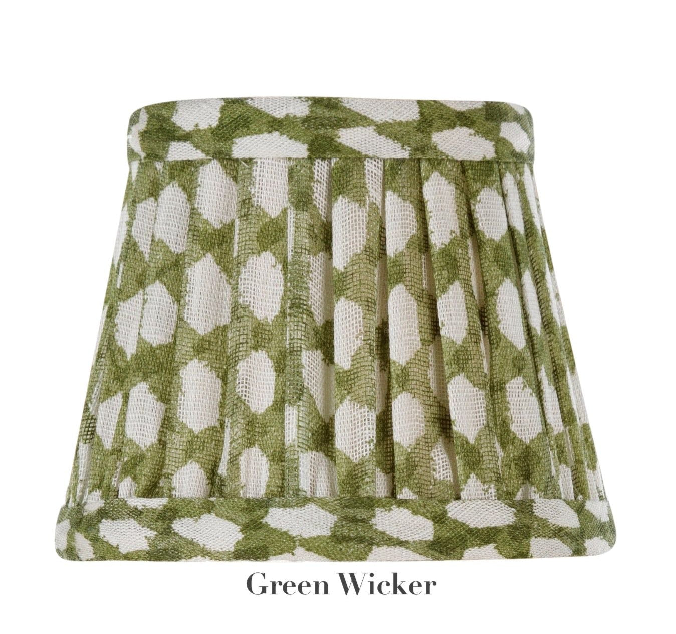 A pleated fabric lampshade with a green and white geometric pattern, part of the Zafferano x Fermoie Poldina Lampshade Collection by Zafferano America. Text says "Green Wicker.