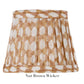 The Zafferano America "Nut Brown Wicker" lampshade from the Zafferano x Fermoie Poldina Collection showcases a nut brown and white geometric pattern that echoes Fermoie's artisanal hand-made design charm.