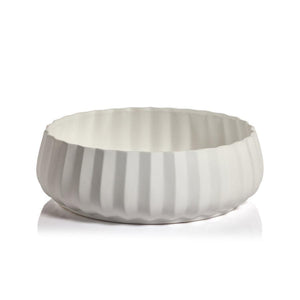 The Catalina Ceramic Bowl Collection by Zodax features a white, round ceramic bowl with a scalloped, ribbed exterior—an eye-catching centerpiece shown against a plain background.