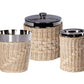 Three kitchen canisters from the Zodax Palmier Barware Collection, featuring stainless steel interiors, black lids, and hand-woven rattan exteriors, bring elegant charm to your bar cart or countertop.