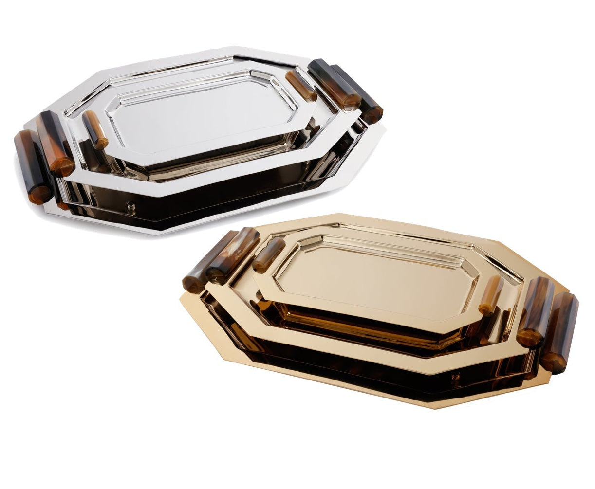 The Zodax Octagon Metal Tray with Horn Handle Collection includes two trays—one polished gold, the other silver—each with bold dark brown horn handles, shown against a white background.