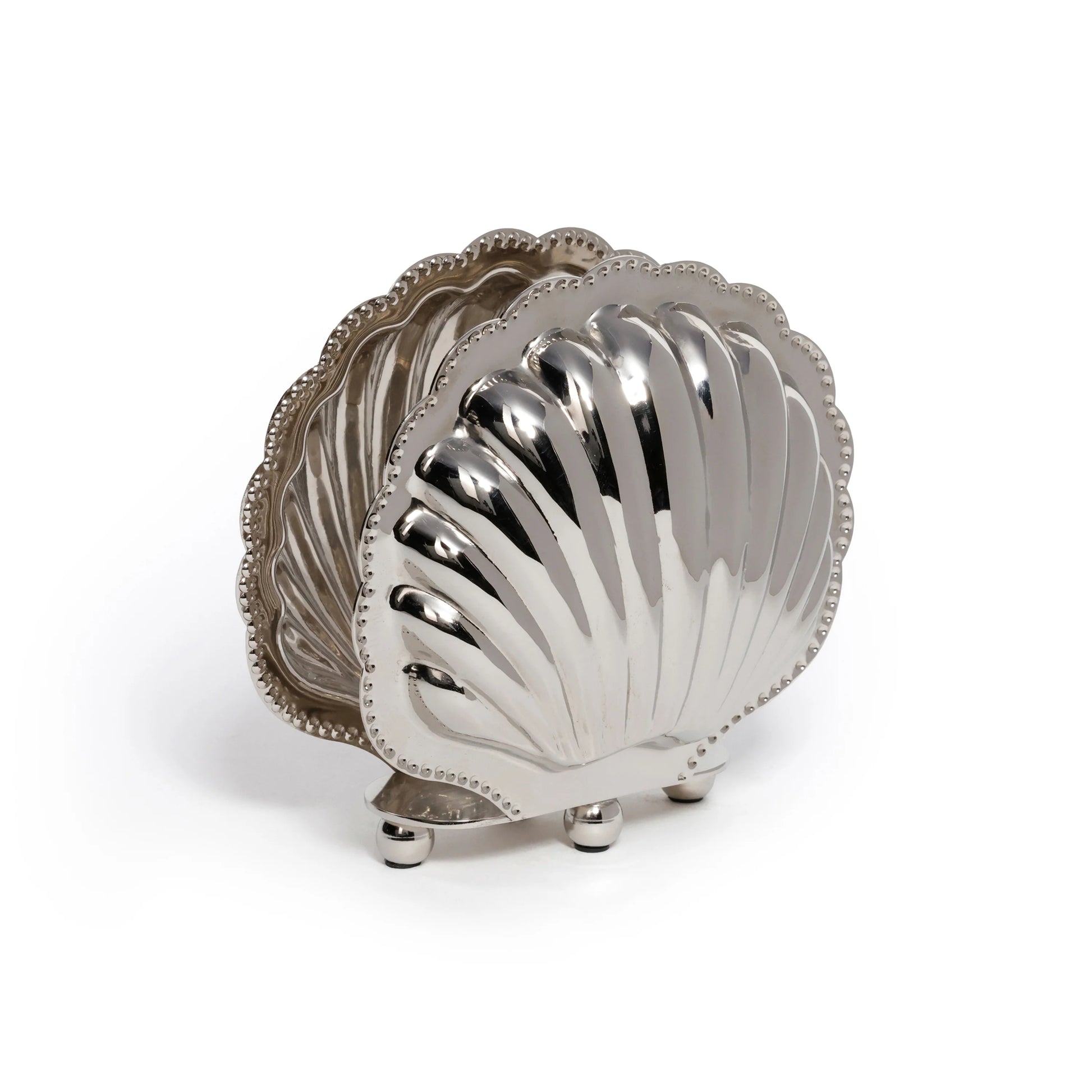 The Zodax Cap Ferrat Fan Shell Napkin Holder features a silver scallop shell design with four round feet, adding coastal elegance to your decor.