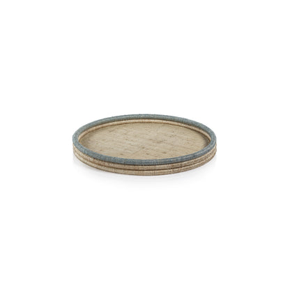 The La Côte Coiled Round Tray Collection by Zodax features a round rattan serving tray in beige and blue tones, ideal for coastal décor, shown on a white background.
