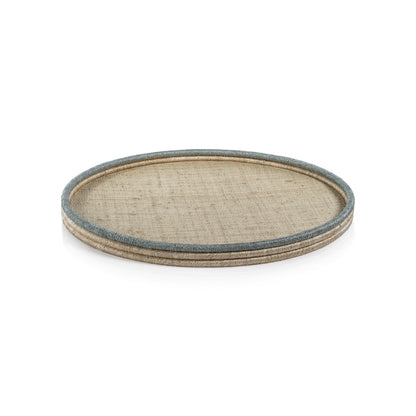The La Côte Coiled Round Tray Collection by Zodax features a light rattan serving tray with a blue-gray rim, ideal for coastal décor. Shown on a white background.