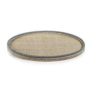 The La Côte Coiled Round Tray Collection by Zodax features a round rattan tray with a beige woven surface and light blue-trimmed raised edge—ideal for adding a coastal touch to your décor.