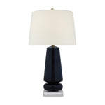The Parisienne Lamp Collection by Visual Comfort features a modern table lamp with a glossy black ceramic body, a large white fabric shade, and a reflective square base to create an inviting ambient glow.