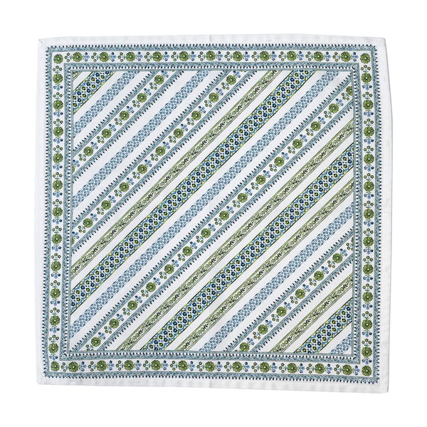 The Seville Green Stripe Table Linen Collection by Juliska features square linens with diagonal blue, green, and white stripes, plus floral and geometric borders inspired by the classic Seville motif.