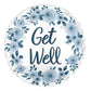 The Signature Balloon by Burton+Burton features a round design adorned with a floral wreath and the words "Get Well" in the center. The flowers and text come in varying shades of blue, perfectly complementing our exquisite floral arrangements available for local delivery.