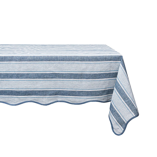 The Juliska Cabana Stripe Tabletop Collection's breezy linen tablecloth in blue and white cabana stripes elegantly drapes over the table.