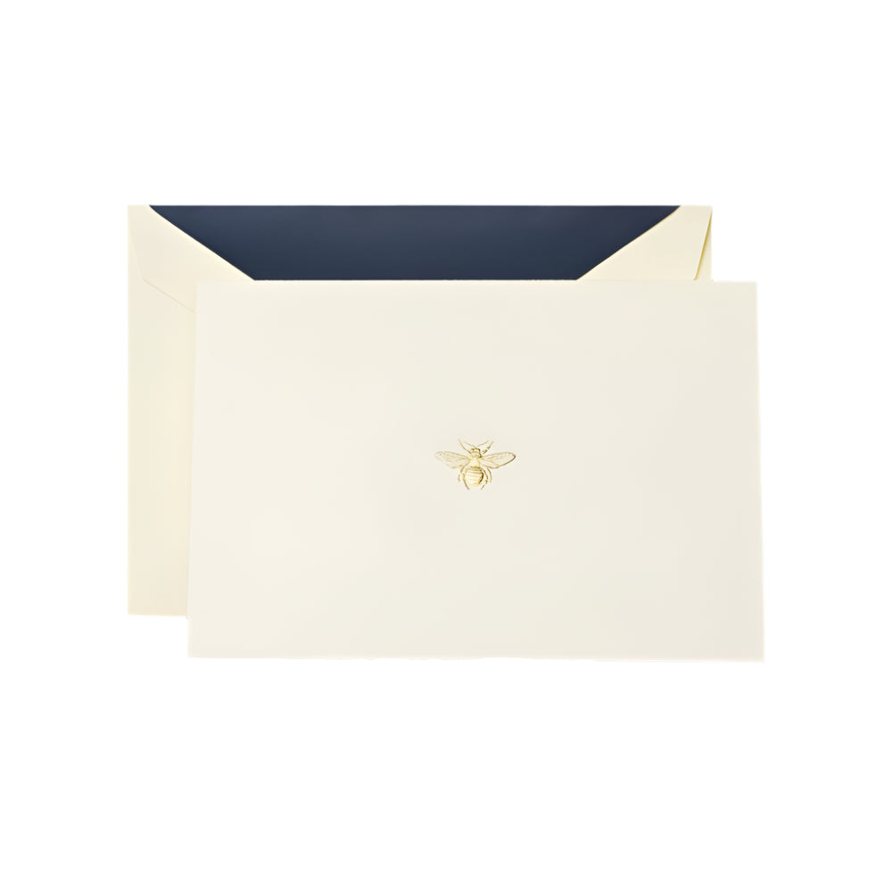 Crane's Bee Classic Card Set includes an ecru card and envelope with a gold bee emblem and dark blue lining, all set on a white background—ideal for sending thoughtful handwritten notes.