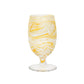 The Juliska Puro Marbled Drinkware Collection features a clear-stemmed goblet with yellow and white swirled glass, evoking seaglass tones, shown against a plain white background.
