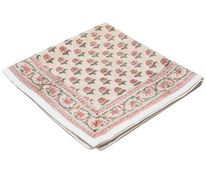 A folded beige cloth napkin from the Alwar Table Linen Collection by SLOANE BY HAND, featuring hand block printed red and green florals with a decorative border—ideal for mixing and matching with your favorite tableware.