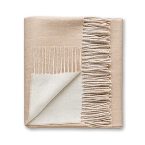 The Alicia Adams Alpaca Reversible Throw, in beige and white with fringe on one edge, is crafted for refined softness and shown on a white background.