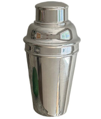 The Hôtel Silver Vintage Cocktail Shaker with Built-in Citrus Juicer stands upright against a plain background—an essential reflective silver bar accessory for any home mixologist.