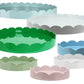 The Addison Ross Round Scalloped Lacquer Tray Collection features glossy trays in green, white, blue, pink, and light green, arranged in various sizes against a white background.