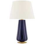 The Penelope Table Lamp Collection by Visual Comfort features a glossy dark blue base, gold accents, and a white tapered shade for a modern look that brings warm ambient light to any space.