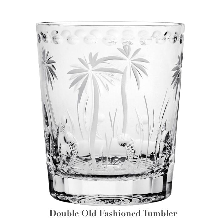 A clear glass tumbler with hand-cut palm tree and grass designs, labeled "Double Old Fashioned Tumbler" beneath; part of the handmade Alexis Collection by William Yeoward Crystal.