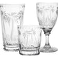 The Alexis Collection by William Yeoward Crystal features handmade crystal glasses—a tall tumbler, short tumbler, and wine glass—with hand-cut palm tree designs.