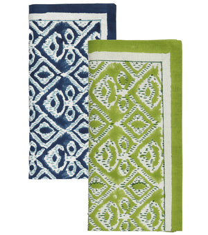 The Kim Seybert Alfresco Napkin Set features two folded cotton napkins with blue and white, and green and white geometric patterns—perfect for any table setting and inspired by traditional block printing.