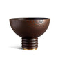 The Alhambra Bowl Collection by L'Objet features a dark Smoked Ash Bowl with a textured grain, rounded body, ribbed circular base, and metallic accent—an elegant decorative piece inspired by Alhambra Gardens.