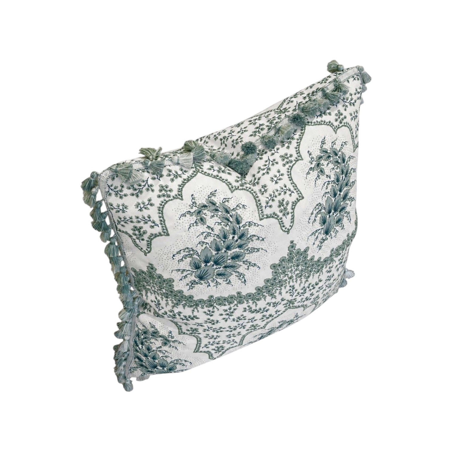 The Alhambra Pillow by Hive Custom Pillows features a green and white floral design with tasseled edges, blending luxury and style to elevate any space.