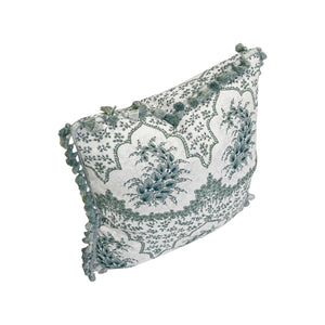 The Alhambra Pillow by Hive Custom Pillows features a green and white floral design with tasseled edges, blending luxury and style to elevate any space.