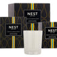 Three boxes of the Nest Amalfi Lemon & Mint Collection evoke the freshness of the Amalfi Coast, elegantly displayed behind a white glass holder Mint candle.