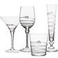 The Amalia Drinkware Collection by Juliska features four types—martini glass, wine glass, tumbler, and champagne flute—with intricate spiral ribbon and glass bead designs, all handcrafted by master artisans.