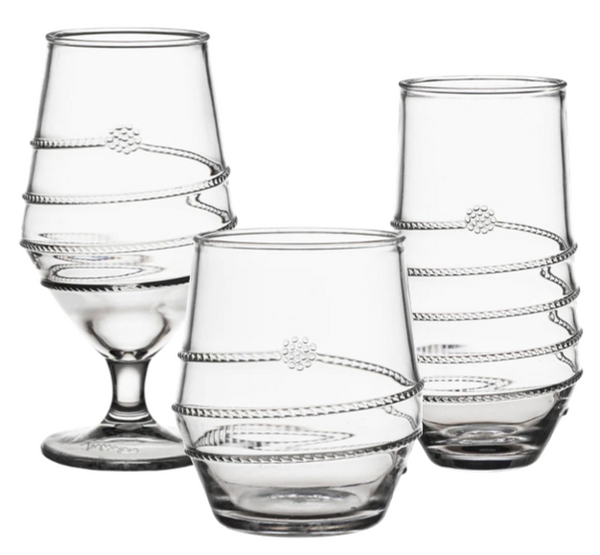 Three drinking vessels from the Juliska Amalia Clear Acrylic Collection by Juliska, each featuring decorative winding patterns and crafted from clear acrylic. The set includes a sleek stemless tumbler for modern flair, along with glasses of varying shapes and heights.