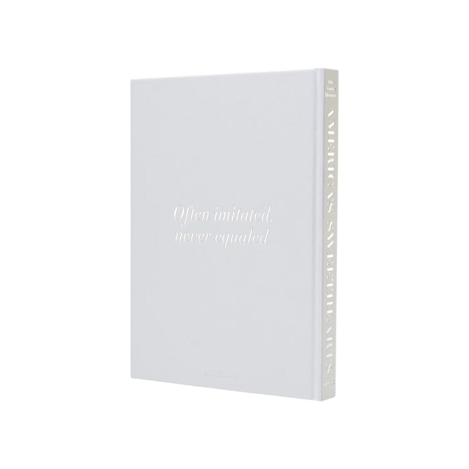 A white Assouline hardcover book titled "America's Sweethearts- Dallas Cowboys Cheerleaders" stands upright against a plain background, celebrating the iconic spirit and cultural impact of the famous cheerleading team.