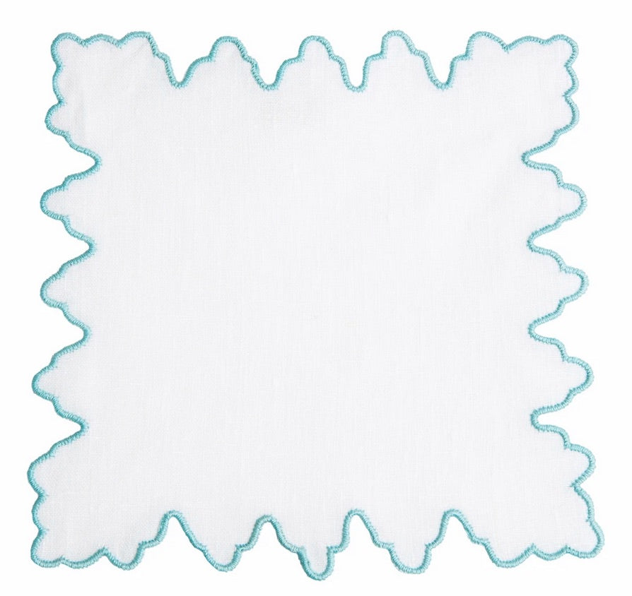 The Haute Home Sultan Coaster Set features white square handkerchief coasters with blue scalloped edges—an elegant touch for home décor or your next gathering.