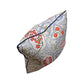 The Arboretum Pillow by Hive Custom Pillows is a handmade square pillow with multicolored floral and geometric patterns in red, blue, and green on white. It’s 100% down-filled for luxurious comfort.