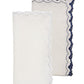 The Kim Seybert Arches Napkin Set features two folded linen napkins: one white with matching trim, and one light beige accented by a dark blue geometric embroidered border.