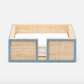 A woven rectangular napkin holder from the Gable Natural/White Barware Collection by Blue Pheasant with light blue leather trim holds a stack of white napkins, shown front view.