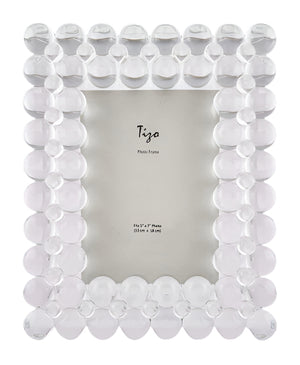 The Crystal Glass Double Bubble Frame Collection by Tizo Design features a whimsical border of rounded bubbles and a clear glass center—perfect for showcasing your favorite photos on any tabletop.