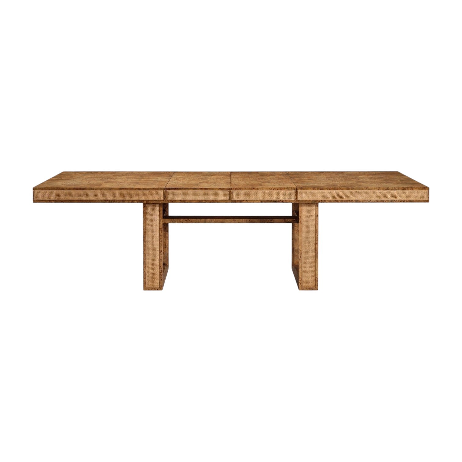 The Dariel Extension Dining Table by Made Goods features a rectangular wooden top with two wide pedestal legs, a horizontal support beam, and natural burl patterns for added texture.