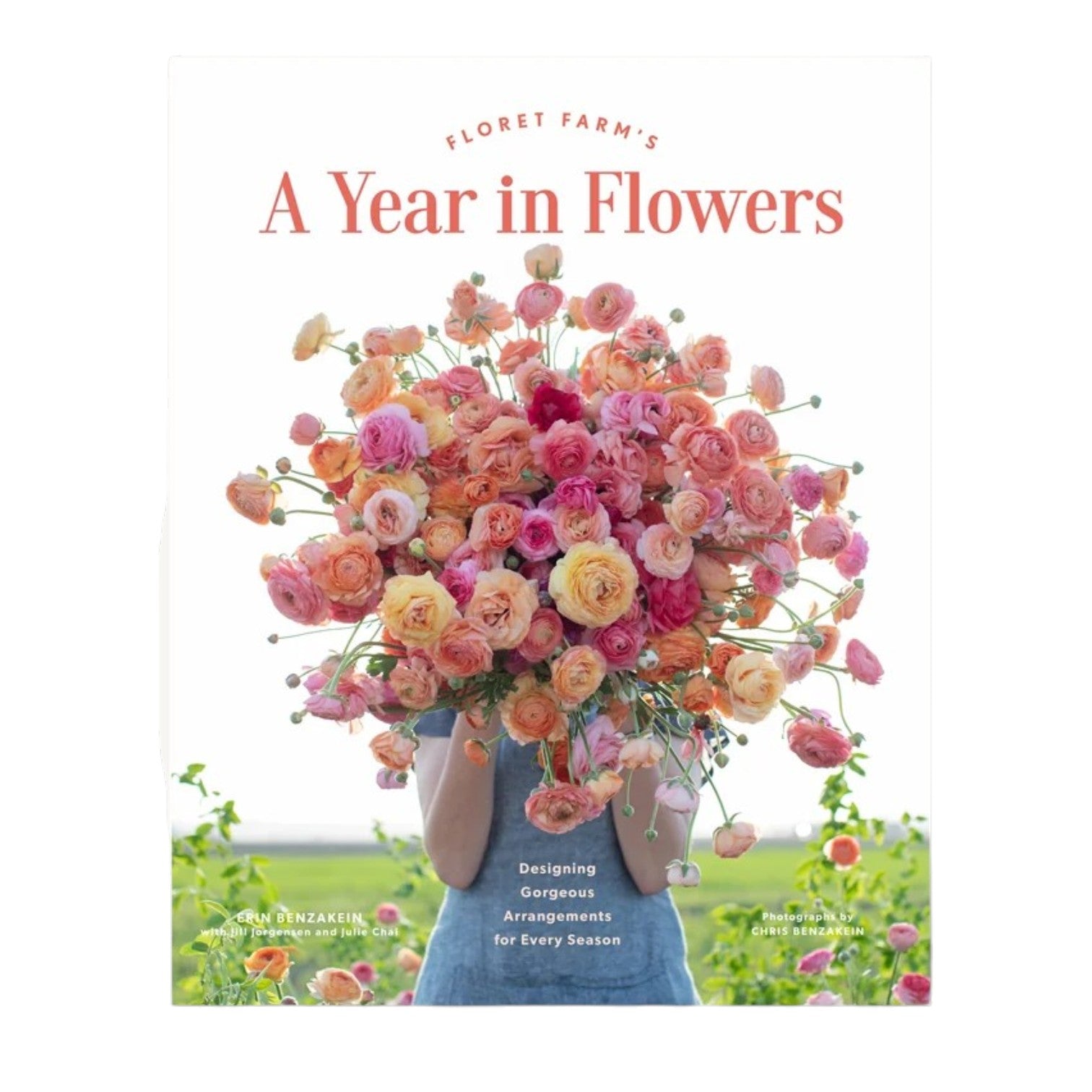 A person holds a large bouquet of pink and orange flowers in front of their face, showcasing the stunning floral design featured on the cover of “A Year in Flowers” by Chronicle Books.